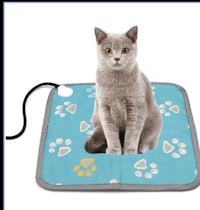 a cat on a heating pad with paw prints